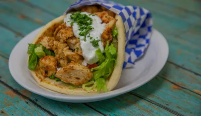Fresh chicken kabob pita sandwich with tzatziki sauce and vegetables at Yanni's Gyros