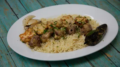 Mixed chicken and lamb kabob combination with rice and grilled vegetables at Yanni's Gyros