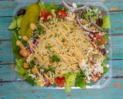 Fresh Greek rice bowl with vegetables, feta cheese, and house dressing at Yanni's Gyros